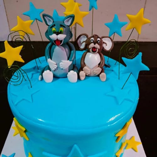 Tom and Jerry Cake Looking for a fun and playful cake idea for your child's birthday party? Try making a Tom and Jerry Cake! This cake features a rich chocolate sponge cake, filled and frosted with smooth and creamy vanilla buttercream, and decorated with fondant Tom and Jerry characters. The cake is not only visually appealing, but also deliciously decadent and indulgent. Your little one and their guests will love the whimsical design and the playful theme. With this recipe, you can create your own Tom and Jerry Cake at home and add a touch of fun to any special occasion.