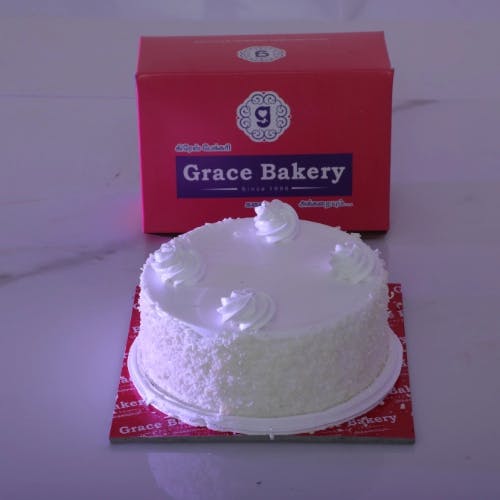 White Forest Cake Indulge in the deliciousness of Grace Bakery's White Forest Cake, a heavenly combination of white chocolate, fresh cream, and cherries. Perfect for any celebration!